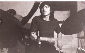 Ann Day in performance, playing drum kit.