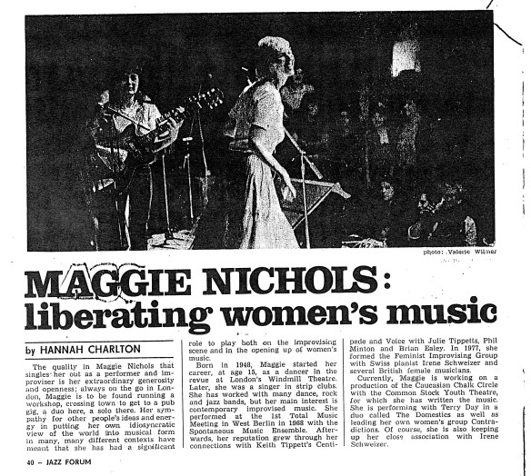 Newspaper clipping headed 'Maggie Nicols: liberating women's music.' The interview outlines Maggie's career, beginning by noting the 'quality as a performer and improviser' that marks her out, ' her generosity and openness; always on the go, running a workshop, a pub gig, a duo here, a solo there.' In the accompanying photo of Maggie singing on stage, with guitarist Sally, a rapt women's audience watches.