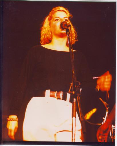 Singer on stage with microphone, from the same gig as other photos, showing the band really lively and energetic in performance.