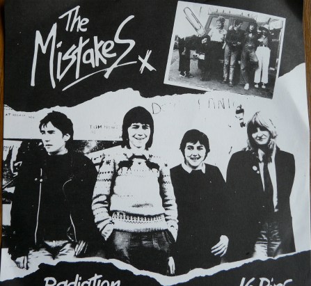 Cover for 'Radiation.' Black and white image of band with handwritten 'The Mistakes' x 