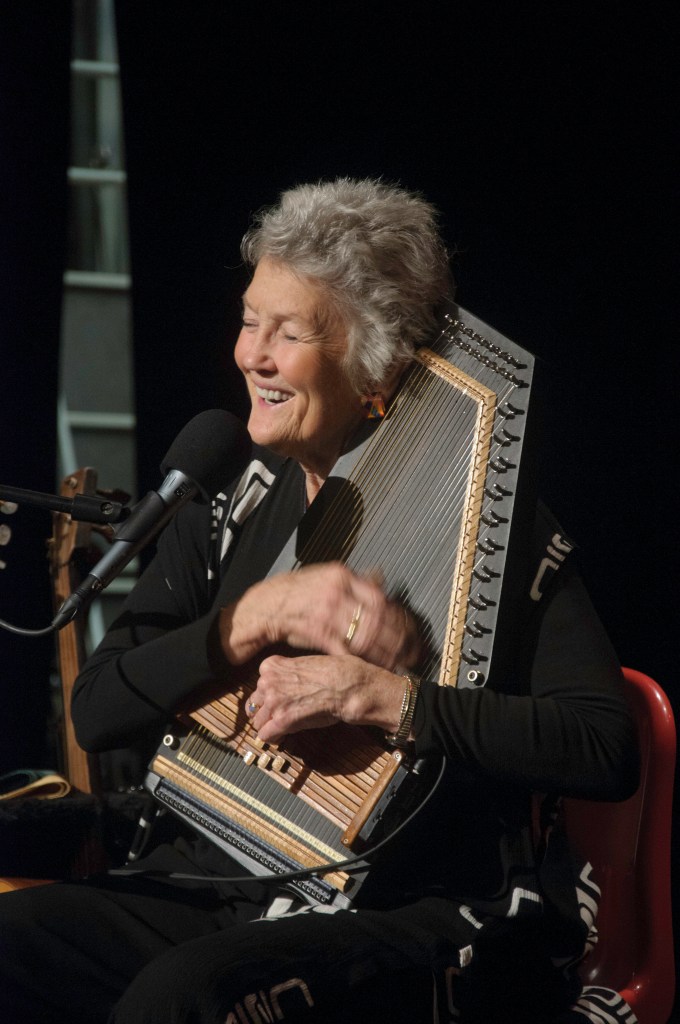 Peggy in concert, singing and playing dulcimer.