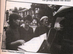 Four members of the Siren group photographed with their van and consulting a map.