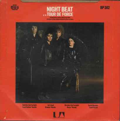 Colour photo of the band dressed in black leather. Framed by a red background. All titles written by Tour de Force, AMP productions.