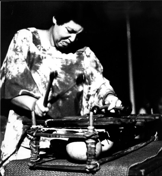 Terri Quaye performing solo in farewell concert at Africa Center 1982, playing balathon, an African instrument akin to axylophone.