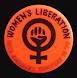 Orange badge with clenched fist inside women's symbol and words 'Women's Liberation.'