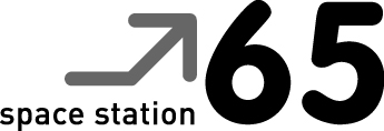 Space Station 65 logo The logo includes an arrow pointing upwards and the words 'space station 65'